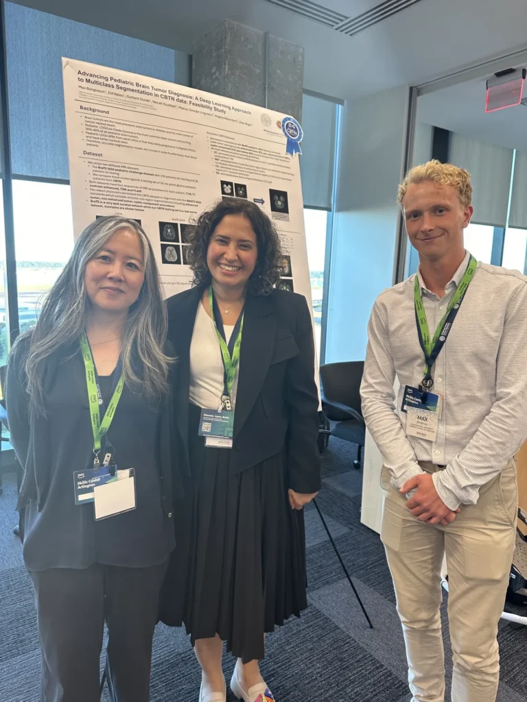 Three attendees beside a scientific poster at CBTN 2024